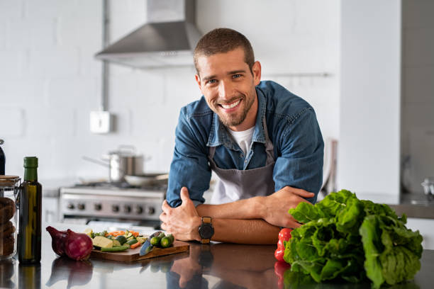 Young man leaning on kitchen counter Young man leaning on kitchen counter