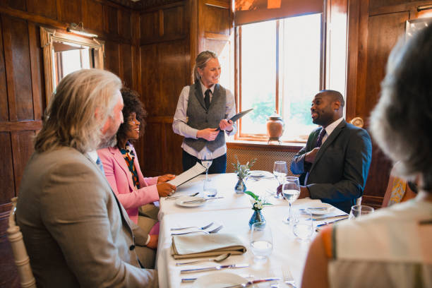 Group of well-dressed colleagues dining in a luxury restaurant Group of well-dressed colleagues dining in a luxury restaurant