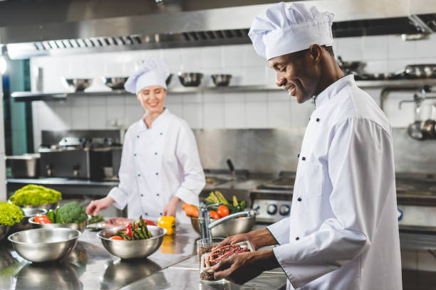 chef holding tray in restaurant kitchen chef holding tray in restaurant kitchen