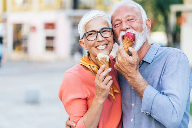 senior couple eating ice cream senior couple eating ice cream